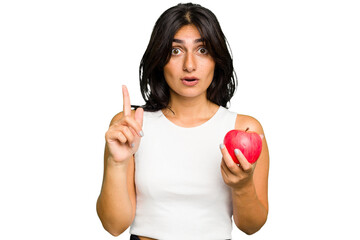 Young Indian woman holding an apple, healthy lifestyle, isolated having some great idea, concept of creativity.