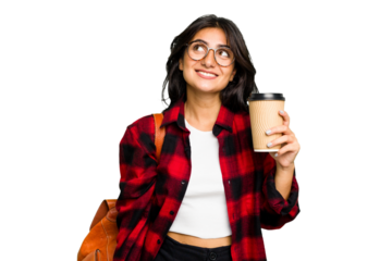 Young student Indian woman holding a take away coffee isolated dreaming of achieving goals and purposes
