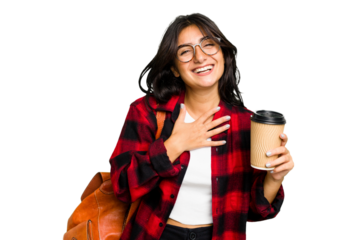 Young student Indian woman holding a take away coffee isolated laughs out loudly keeping hand on chest.