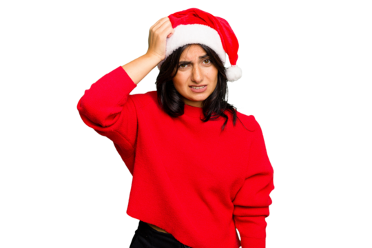 Young Indian woman celebrating Christmas wearing a santa hat isolated being shocked, she has remembered important meeting.