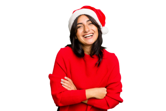 Young Indian woman celebrating Christmas wearing a santa hat isolated laughing and having fun.