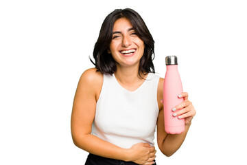 Young Indian woman holding a thermo isolated laughing and having fun.