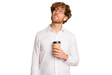 Business caucasian man holding a coffee to take away isolated on white background dreaming of achieving goals and purposes