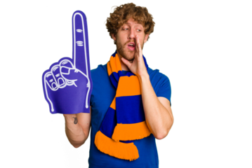 Young caucasian sports fan man isolated on white background is saying a secret hot braking news and looking aside