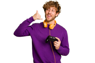 Young caucasian gamer man holding a game controller isolated on white background showing a mobile...