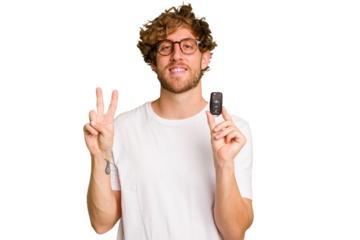 Young caucasian man holding car keys isolated on white background showing number two with fingers.