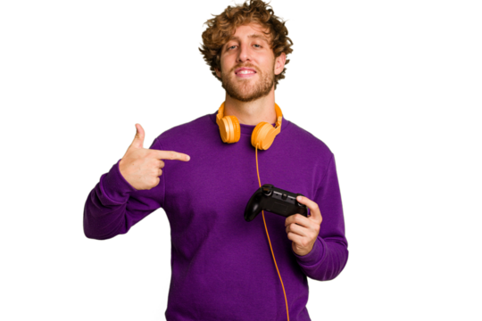 Young caucasian gamer man holding a game controller isolated on white background person pointing by hand to a shirt copy space, proud and confident