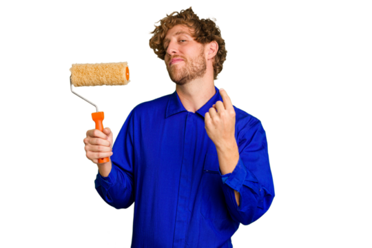 Young painter man holding a roll isolated on white background pointing with finger at you as if inviting come closer.
