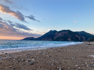 Sunrise landscape with clouds and sea. View of the sun rising above the sea. Selective focus.
