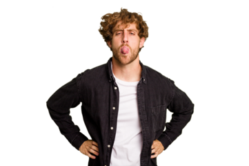 Young caucasian man isolated on green chroma background funny and friendly sticking out tongue.