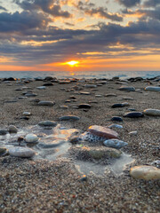Sunrise landscape with clouds and sea. View of the sun rising above the sea. Selective focus.