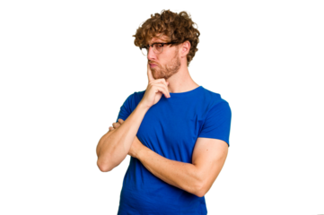 Young caucasian man isolated on green chroma background contemplating, planning a strategy, thinking about the way of a business.