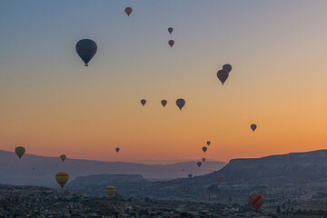 Hot air balloons above Goreme village in Cappadocia, Turkey