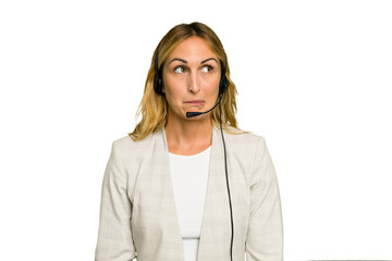 Telemarketer caucasian woman working with a headset isolated on green chroma background confused,...