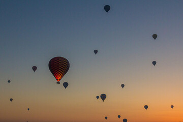 Early morning aerial view of hot air balloons above Goreme village in Cappadocia, Turkey