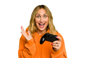 Young caucasian gamer woman holding a game controller isolated on green chroma background surprised and shocked.