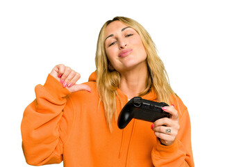 Young caucasian gamer woman holding a game controller isolated on green chroma background feels...