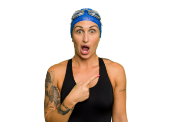 Young caucasian swimmer woman isolated on green chroma background pointing to the side