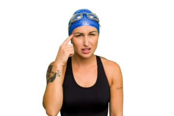 Young caucasian swimmer woman isolated on green chroma background showing a disappointment gesture with forefinger.
