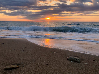 Sunrise landscape with clouds and sea. View of the sun rising above the sea. Selective focus.