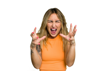 Young caucasian woman isolated on green chroma background screaming with rage.