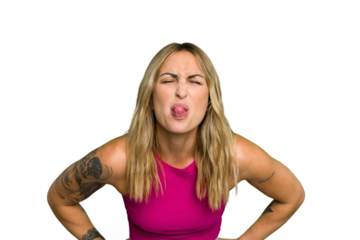 Young caucasian woman isolated on green chroma background funny and friendly sticking out tongue.