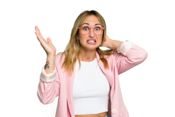 Young caucasian woman isolated on green chroma background screaming with rage.