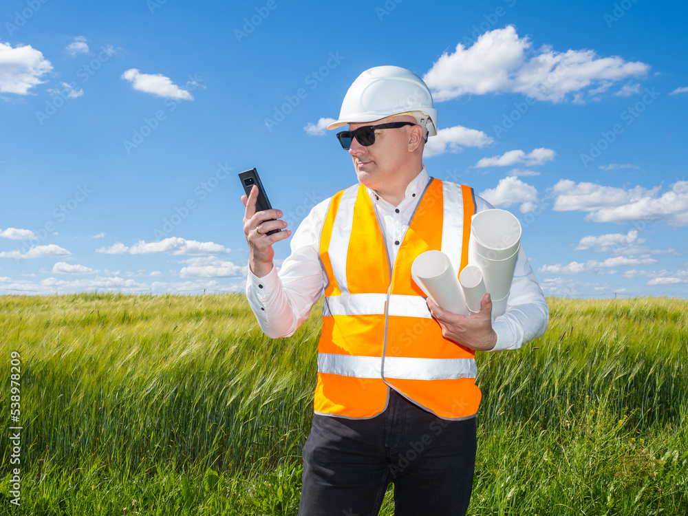 Poster architect in picturesque location. man in builder's uniform. architectural employee with phone. arch