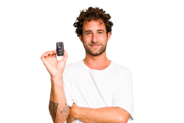 Young caucasian man holding car keys isolated laughing and having fun.