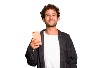 Young caucasian man using mobile phone isolated happy, smiling and cheerful.