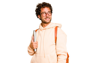 Young caucasian student man isolated looks aside smiling, cheerful and pleasant. - obrazy, fototapety, plakaty