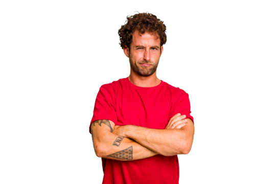 Young caucasian curly hair man isolated Young caucasian man with curly hair isolated frowning face in displeasure, keeps arms folded.