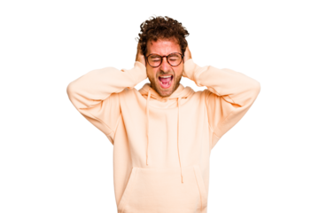 Young caucasian curly hair man isolated Young caucasian man with curly hair isolated covering ears with hands trying not to hear too loud sound.