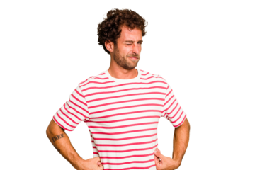 Young caucasian curly hair man isolated Young caucasian man with curly hair isolated frowning face in displeasure, keeps arms folded.