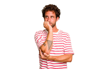 Young caucasian curly hair man isolated Young caucasian man with curly hair isolated biting fingernails, nervous and very anxious.