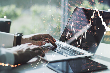 Multi exposure of abstract creative financial chart with world map and with hand typing on computer keyboard on background, research and analytics concept