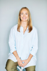 Studio portrait of beautiful young woman on blue background