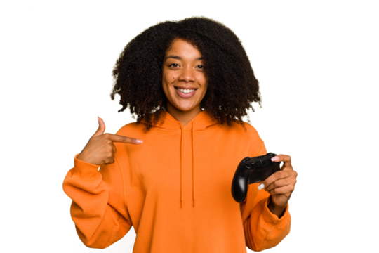 Young African American woman holding a game controller isolated person pointing by hand to a shirt copy space, proud and confident