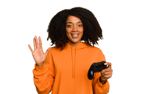 Young African American woman holding a game controller isolated smiling cheerful showing number five with fingers.