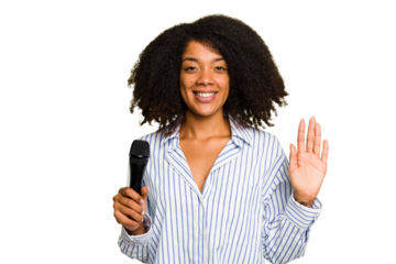Young African American singer woman holding a microphone isolated smiling cheerful showing number five with fingers.