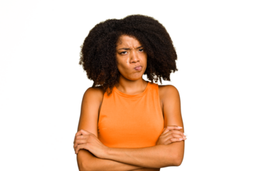 Young African American woman isolated frowning face in displeasure, keeps arms folded.
