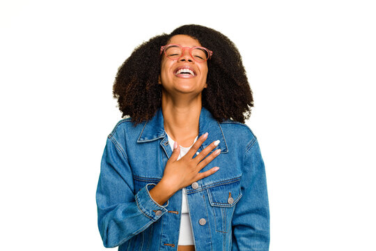 Young African American woman isolated laughs out loudly keeping hand on chest.