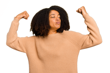 Young African American woman isolated showing strength gesture with arms, symbol of feminine power