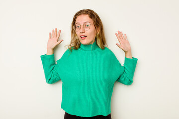 Young caucasian woman isolated on white background being shocked due to an imminent danger