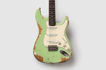 Old green guitar on white background