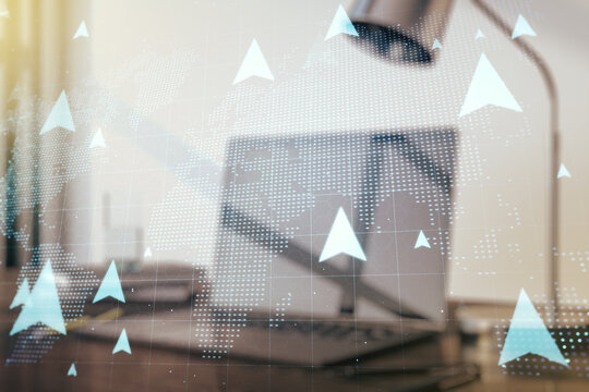 Creative concept of geolocations map on modern laptop background. GPS tracking and navigation concept. Multiexposure