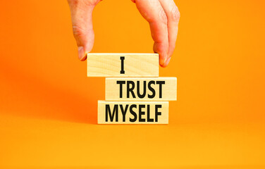 I trust myself symbol. Concept words I trust myself on wooden blocks. Businessman hand. Beautiful...