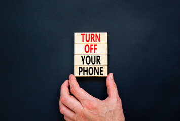 Turn off your phone symbol. Concept words Turn off your phone on wooden blocks. Beautiful black...