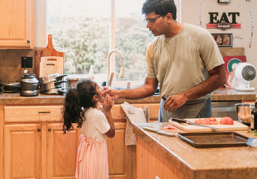 Father feeding his daughter 