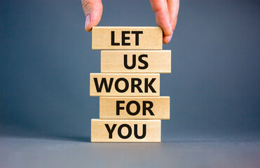 Let us work for you symbol. Concept words Let us work for you on wooden blocks. Businessman hand. Beautiful grey table grey background. Business and let us work for you concept. Copy space.